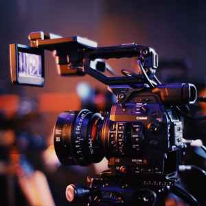 Close-up of a professional video camera setup indoors, capturing high-quality footage.